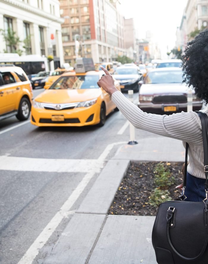 african-american-woman-hailing-a-taxi-cab-in-new-y-2025-01-07-10-26-12-utc